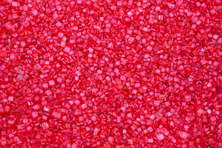 A very close view of ruby red candy sugar sprinkles.の写真素材