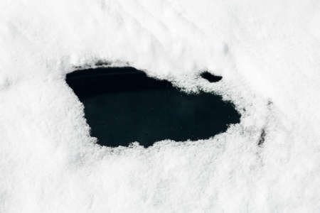 A vehicle with a small hole brushed off the glass to see out through the covering snow.の写真素材