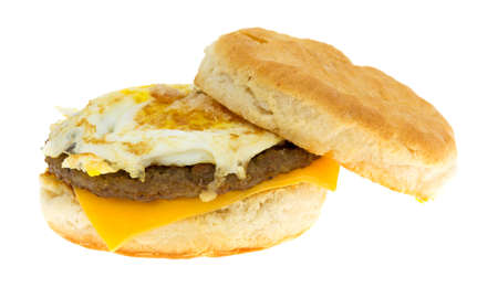 A sausage egg and cheese biscuit breakfast sandwich isolated on a white background.の写真素材