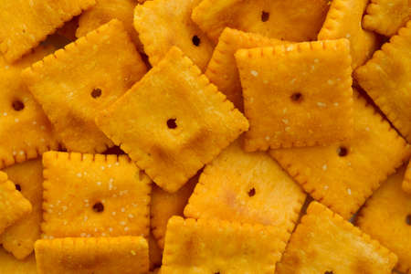 A close view of cheese crackers illuminated with natural light.の写真素材