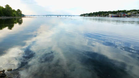 Wide angle view of the Belfast Maine waterfront on an overcast late spring morning with sailboats in the distance.の写真素材