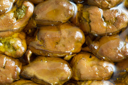 A very close view of smoked whole oysters in cottonseed oil.の写真素材