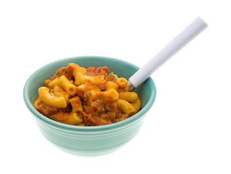A cooked beef and macaroni meal in a small bowl with a spoon on a white background.の写真素材