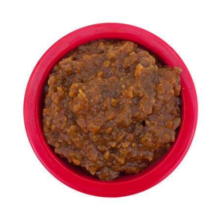 Top view of a red bowl filled with beef and barbecue sauce sloppy joe mix on a white background.の写真素材