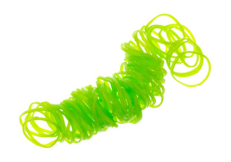 A group of small neon green rubber bands used for hair ponytails on a white background.