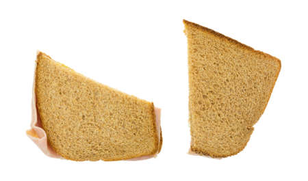Top view of two halves of a ham and cheese sandwich that has been cut in half isolated on a white...