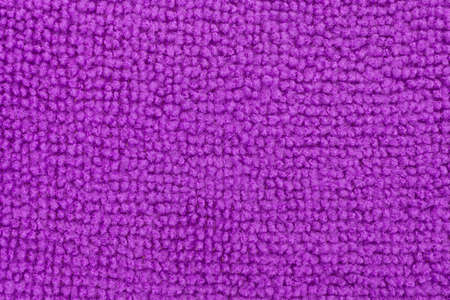 A very close view of a purple microfiber kitchen sponge.の写真素材