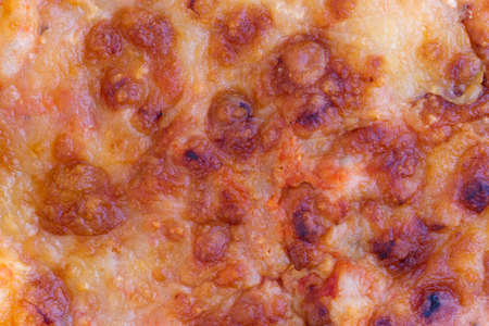 Close view of a cold piece of leftover cheese pizza.の写真素材