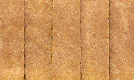 A very close view of the crust of several slices of biscottes.