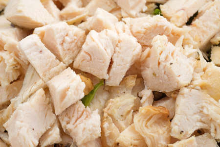 Close view of cut up chicken breast for salad with spinach.の写真素材