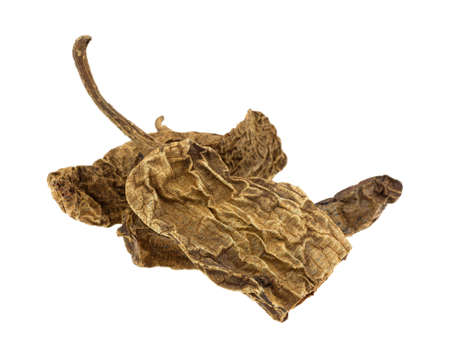 Side view of dried chipotle chile peppers isolated on a white background.