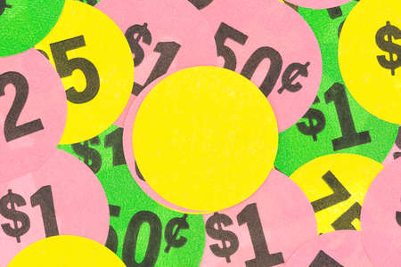 Various denomination generic garage sale stickers with a bright yellow blank label in the center.