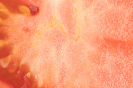 A very close view of a cut in half organic red tomato.の写真素材