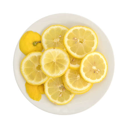 Top view of a slices of fresh lemon on an off white plate isolated on a white background.の写真素材