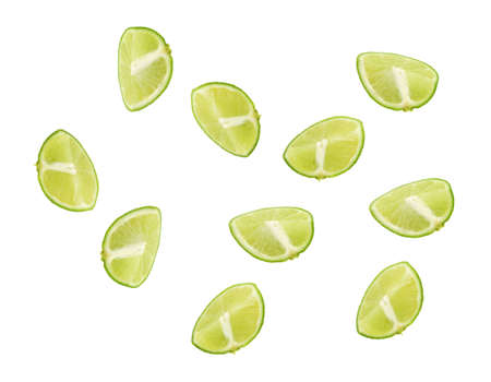 Several cut sections of limes isolated on a white background.