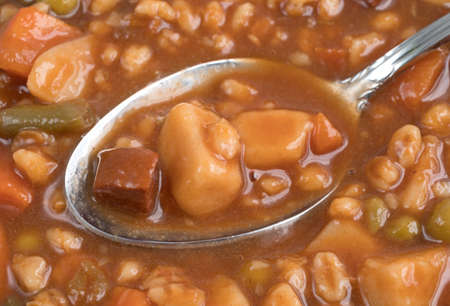 A soup filled with beef stew atop more soup.の写真素材