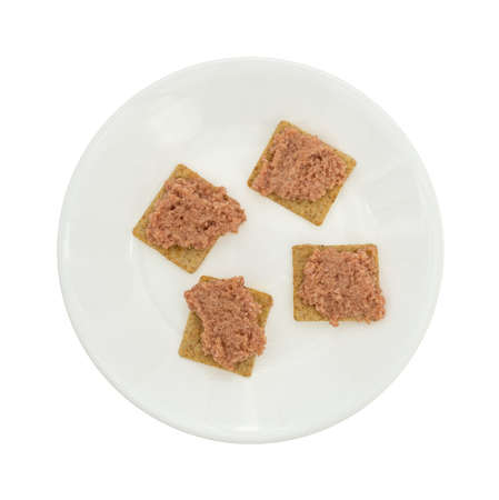 Top view of a plate of deviled ham on wheat crackers isolated on a white background.の写真素材