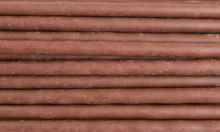 Close view of rows of chocolate coating cookie sticks.の写真素材