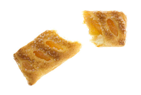 A broken sugar coated apple fruit tart isolated on a white background.の写真素材