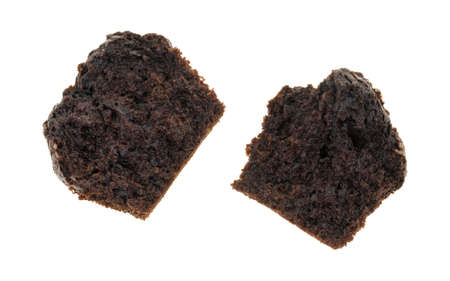 A double chocolate muffin that has been broken in half isolated on a white background.の写真素材