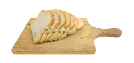 Several slices of freshly baked English muffin toasting bread atop an old wood cutting board...