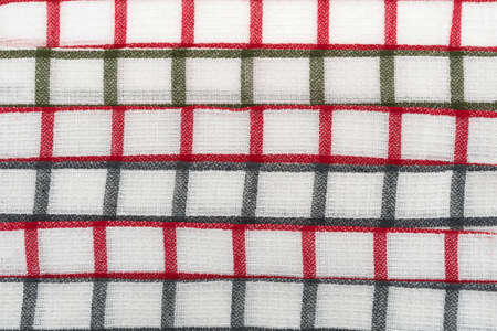 Close view of red and gray pattern dish cloths folded and in rows.