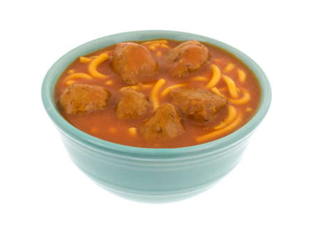 A serving of spaghetti and meatballs in a bowl isolated on a white background.の写真素材