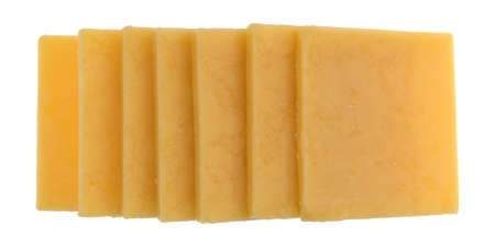 Top view of several slices of gouda cheese in a row isolated on a white background.の写真素材