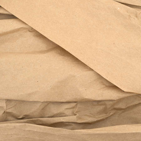 Used brown wrinkled packaging paper with creases.の写真素材