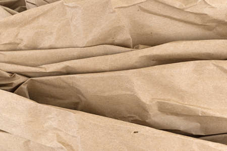 Used brown wrinkled packaging paper with creases.