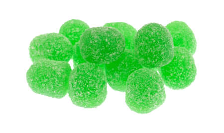 A small portion of green sugar coated sour drop candy isolated on a white background.の写真素材