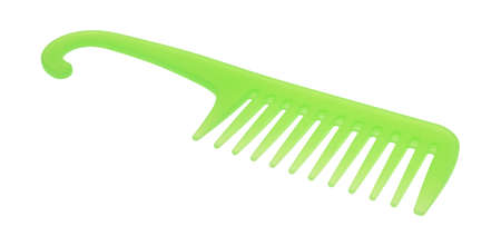 Side view of a large green wide toothed detangling comb isolated on a white background.の写真素材