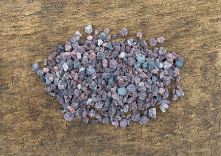Top view of a small pile of Himalayan black salt on an old wood brown board.の写真素材
