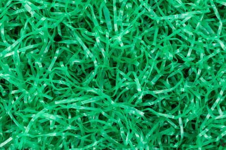 Top view of shredded green plastic Easter grass for lining baskets.の写真素材