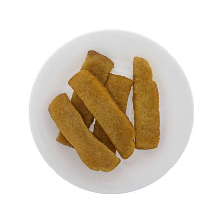 Top view of a serving of French toast sticks on a plate isolated on a white background.