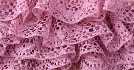 Close view of ruffled lavender lace trim fabric.