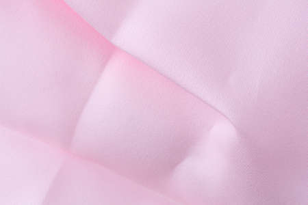 Close view of wrinkled and creased pink fabric.の写真素材