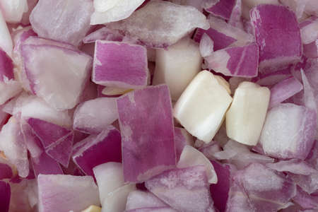 A very close view of freshly chopped red onions.の写真素材