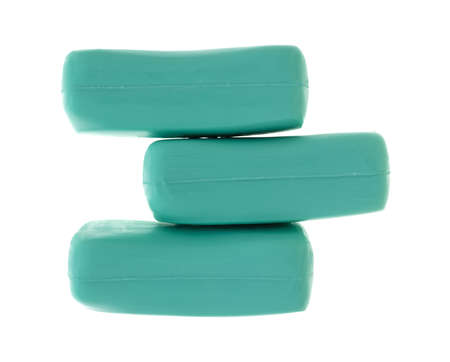 Three bars of deodorant soap in a stack isolated on a white background.