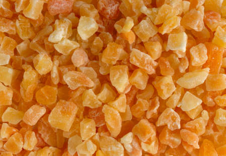 Top close view of dried diced cantaloupe illuminated with window light.の写真素材