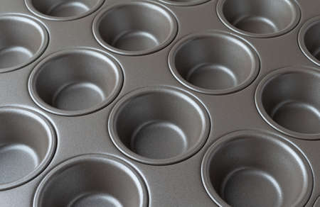 Side close view of a new mini muffin pan illuminated with natural light.