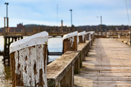 View of the old wood waterfront walkway and pilings at Wiscasset Maine in December.の写真素材
