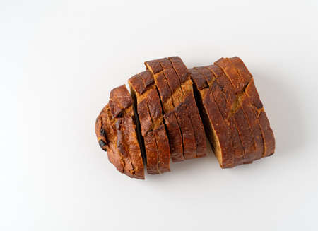 Top view of pumpkin raisin bread slices on a white background illuminated with natural lighting.の写真素材