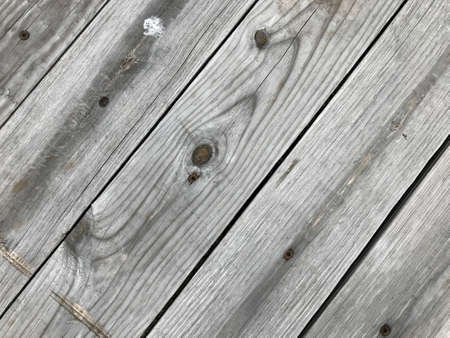 Close view or rows of grayed pressure treated lumber at an angle.