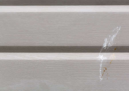 Close view of painted aluminum siding with bird droppings.の写真素材