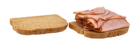 Open faced sandwich with thin sliced ham on wheat bread isolated on a white background.の写真素材
