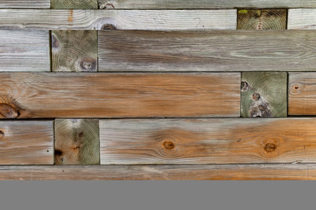 Close view of pressure treated beams used for shoring up a shorefront.