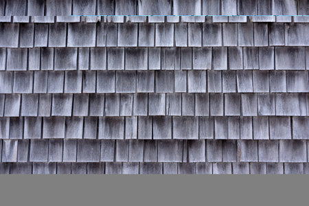 Wide view of cedar shingles which have shrunk and faded gray with age in the early morning light.の写真素材