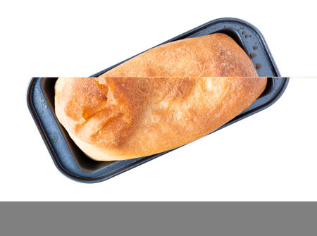 Top view of a loaf of homemade bread at an angle isolated on a white background.