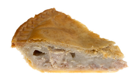 A slice of cold chicken meat pie isolated on a white background side view.の写真素材